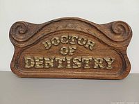 Front view of wooden carved Doctor of Dentistry plaque