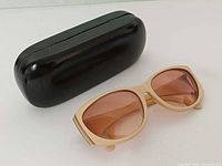 Front view of beige Zeiss sunglasses showing rose lenses