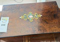 Top view showing burl veneer, inlay and lid crack
