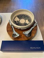 Full set showing salad servers on wooden board inside ceramic bowl with presentation box in foreground