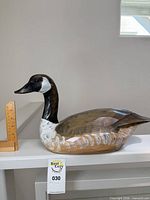 Full side view of decoy with ruler showing size