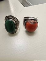 Both sterling silver rings side by side showing malachite and red stones