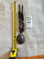 full necklace with tape measure and lot tag to show size and contents