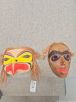Both masks side by side showing scale and overall condition
