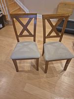Front view of both wooden X-back dining chairs