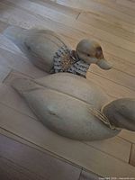 both wooden ducks showing size, shape, finish
