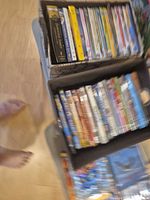 Two boxes of DVDs on stool, overview of lot
