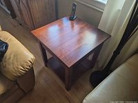 Top view of cherry side table between couches