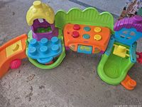 Front view of the Fisher-Price playset showing tower, sound panel, ramps and slide