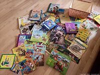 Overview of books, puzzles and decorative box spread on floor