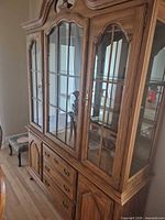 Full view of oak china cabinet showing upper glass hutch and lower drawers