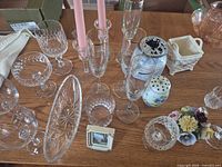 Overview showing crystal goblets, dish, flutes, candlesticks, ceramics and décor