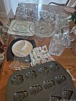 Overview of lot on table including glassware, decanters, cake pan and accessories