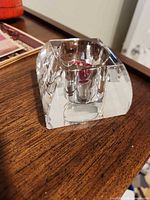 Angled view of crystal tealight holder on wooden surface