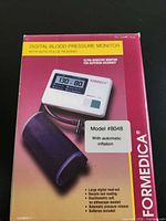 Front of retail box showing monitor, cuff, model and features