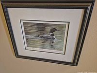 Full view of framed loon print on wall
