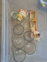 Overview of all egg cups, sugar dish and tray in bin