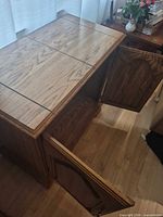 Cabinet with one door open showing flip-top leaves closed