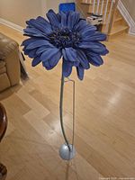 Full view of tall artificial flower with stand