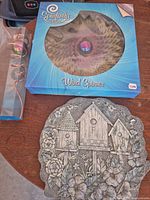 All three items: boxed wind spinner, boxed spiral spinner, round stepping stone