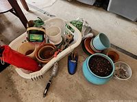 Overall view: pots, tools, fertilizer, basket
