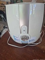 Front view showing control dial, brand label and attached cord