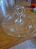 Top view of glass serving plate showing handle and etched pattern