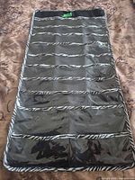 Full view of hanging organizer front showing pockets and zebra trim