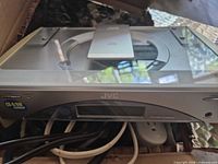 Front view of JVC slim CD receiver with cords visible