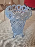 Full view of blue opalescent vase showing diamond lattice body and open lace rim