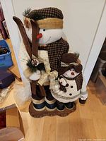 Full view of adult and child snowmen on wooden base