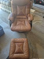 Front view of leather swivel rocker chair with ottoman