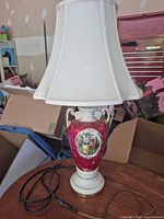 Full view of porcelain lamp with shade and cord