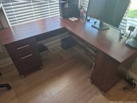 Full view of L-shaped desk showing both wings and drawer pedestal