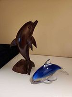 Wooden and glass dolphin figurines group