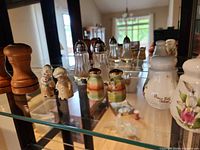 All five shaker sets displayed on glass shelf