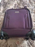 Front view of purple Samsonite carry-on suitcase