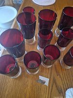Overhead view of all eleven ruby red glasses showing size difference