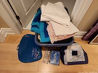 Tote with linens, sewing bag, lap table visible