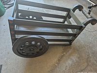 Full view of wooden wagon showing slat body, wheels, overall condition