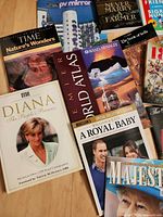 Assorted books and magazines laid out, titles visible