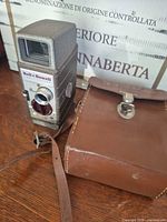 Front view of camera and leather case showing overall condition