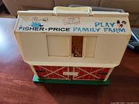 Front of Fisher-Price Play Family Farm barn with handle and graphics