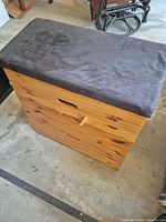 Front view of pine storage chest with padded lid