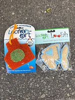 Galaxy Scrubber and fish-shaped scrubber in retail packaging