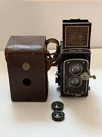 Front view of camera with case and lens caps