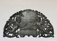 Full view of pewter cherub wall plaque showing overall design and size