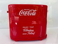 Rear view of red Coca-Cola hot dog toaster showing branding