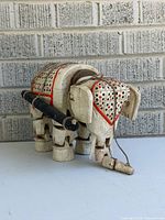 Full view of carved wooden elephant marionette left side