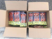 Two open cartons showing multiple sealed red Knork utensil packs